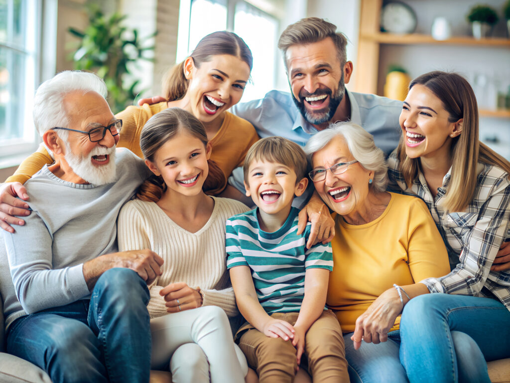 Three generations of a happy family sitting together on a couch